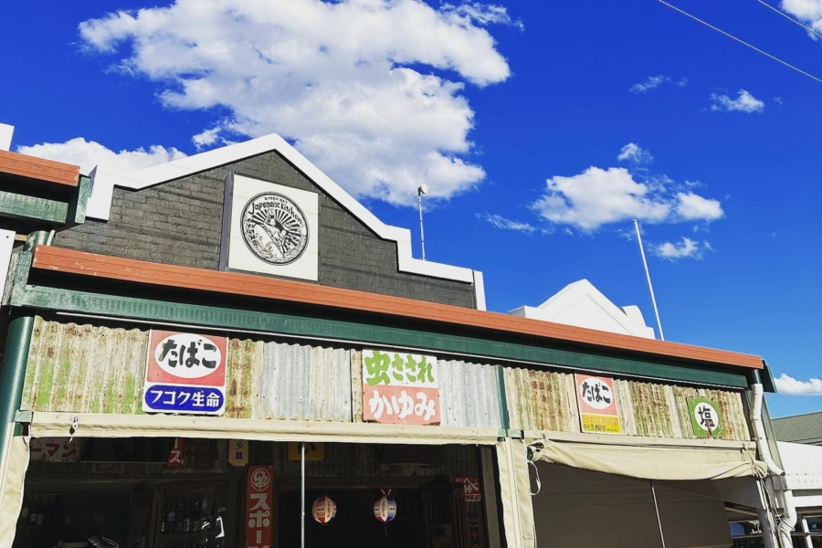 An exterior shot of a restaurant with a japanese theme and blue skies in the background